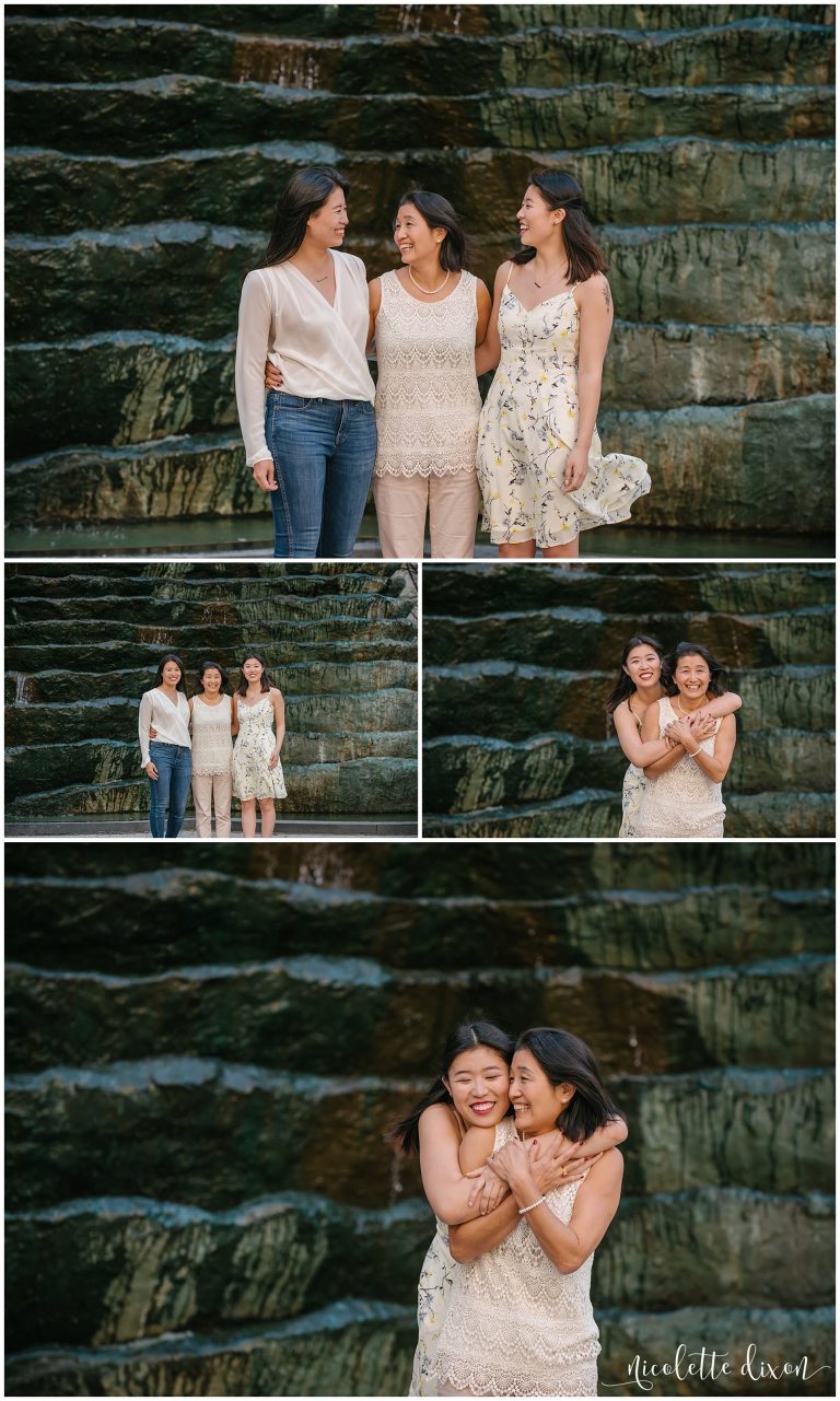 Daughters hugging mom in front of statue in downtown Pittsburgh