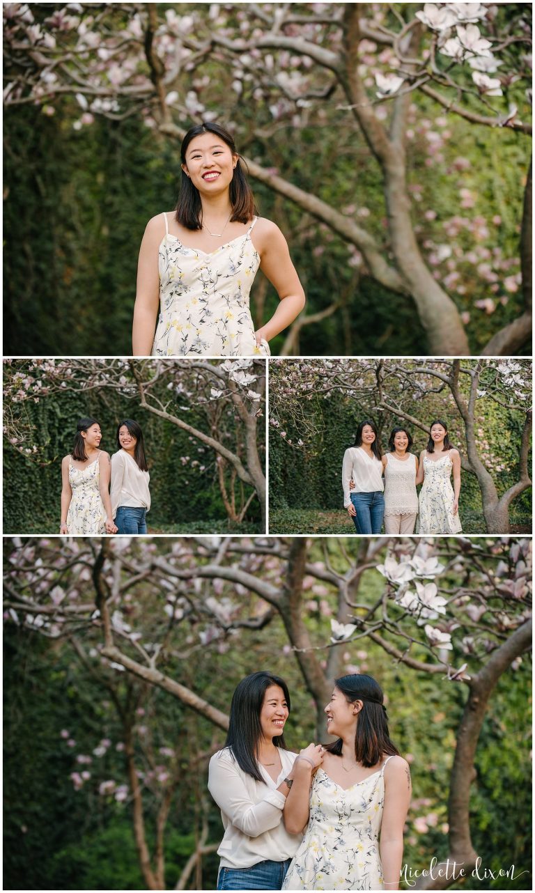 Sisters looking at each other in front of magnolia tree in downtown Pittsburgh