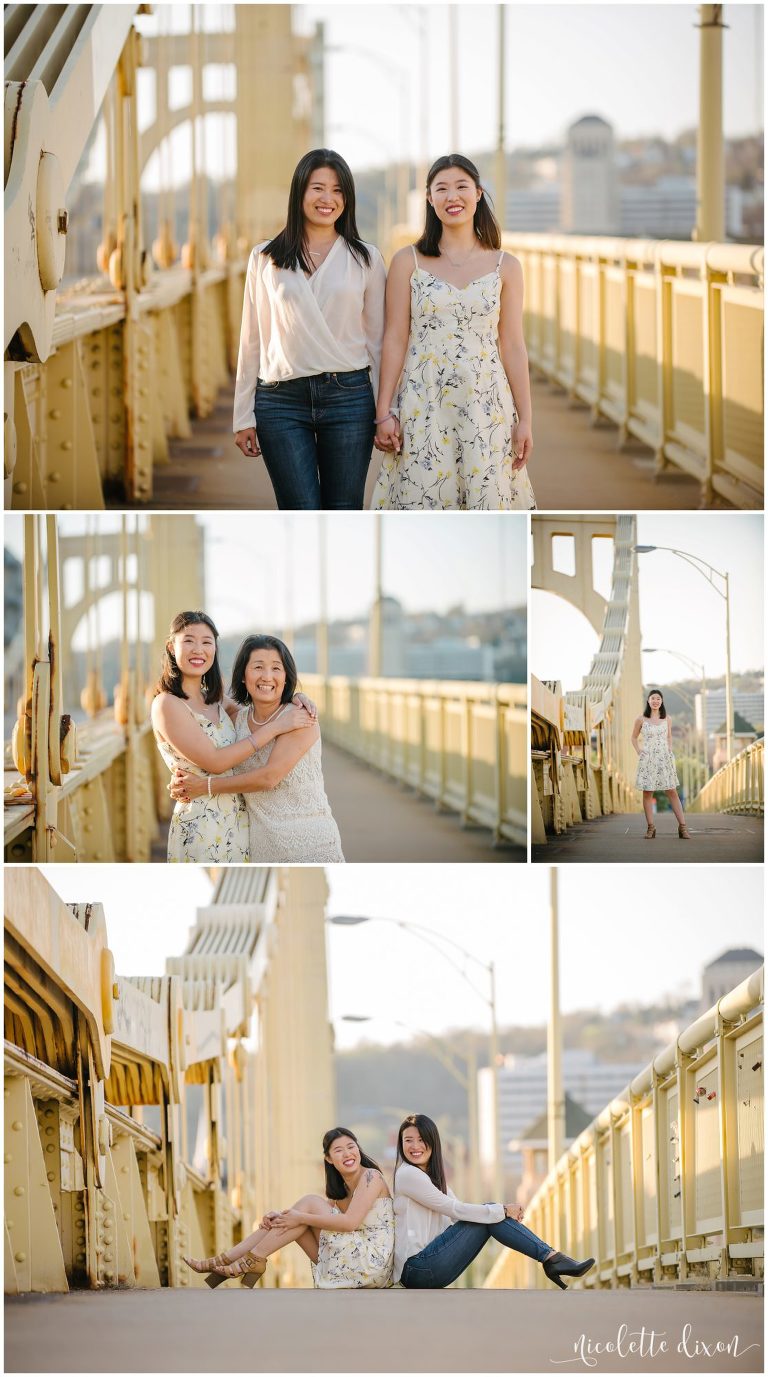 Sisters holding hands walking on bridge in downtown Pittsburgh