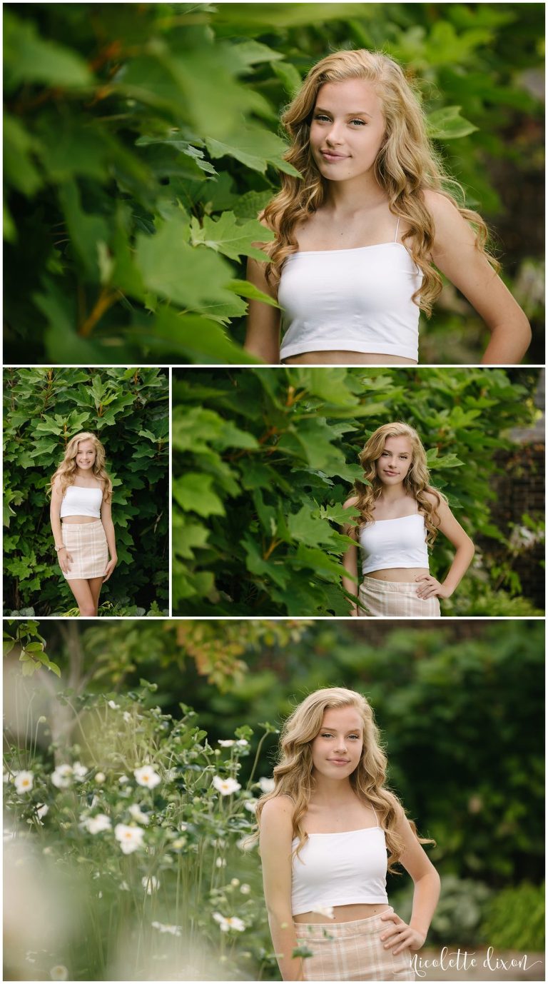 High school senior girl standing by bush at Mellon Park near Pittsburgh