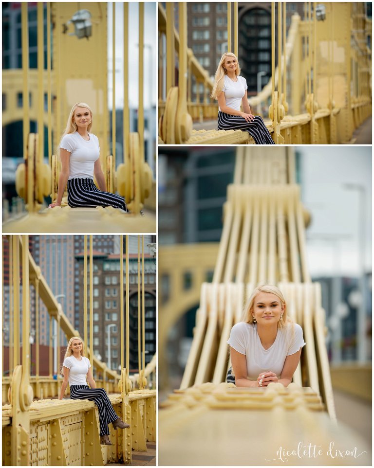 High school senior poses on golden yellow bridges in downtown Pittsburgh