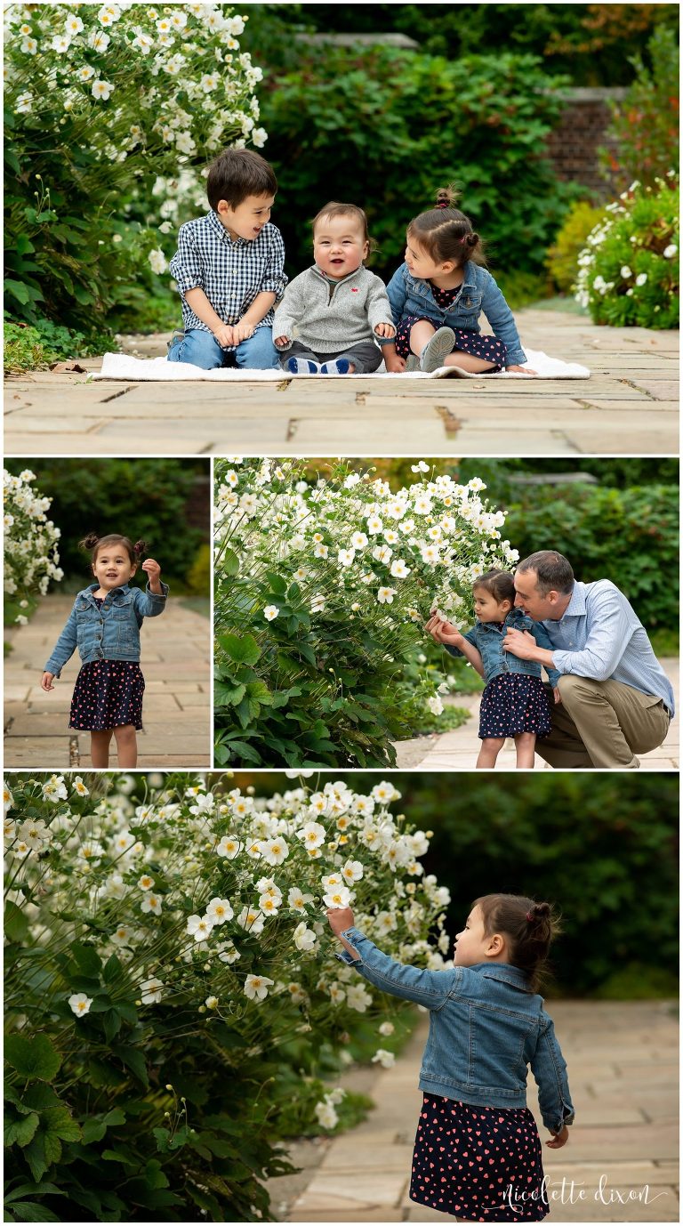 Children sitting on path next to white flowers in Mellon Park near Pittsburgh