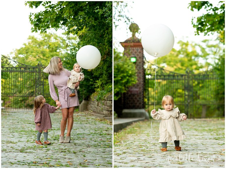 Mom playing with ballon with her two daughters in Mellon Park near Pittsburgh